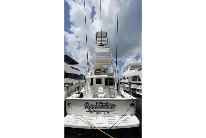Relentless Yacht Photos Pics 1993 Tiara Yachts 4300 Convertible docked in Dunedin, FL under cloudy sky.