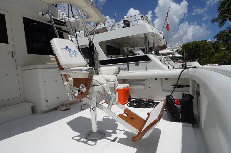 Relentless Yacht Photos Pics 1993 Tiara Yachts 4300 Convertible fishing chair on deck, surrounded by equipment and boats.