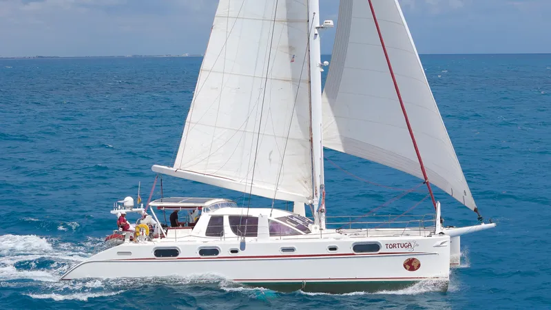 Tortuga Yacht Photos Pics Catana 582 sailing catamaran from 2001 cruising on open blue sea.