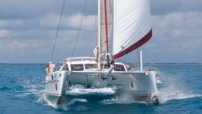 Tortuga Yacht Photos Pics Catana 582 catamaran sailing on open sea, 2001 model, with white sails and blue water.