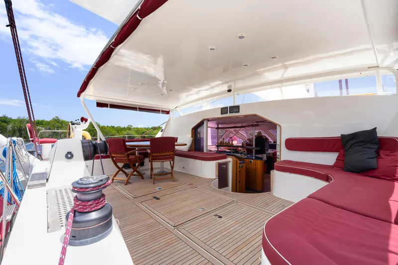 Tortuga Yacht Photos Pics Spacious deck of 2001 Catana 582 yacht with red seating and wooden flooring.