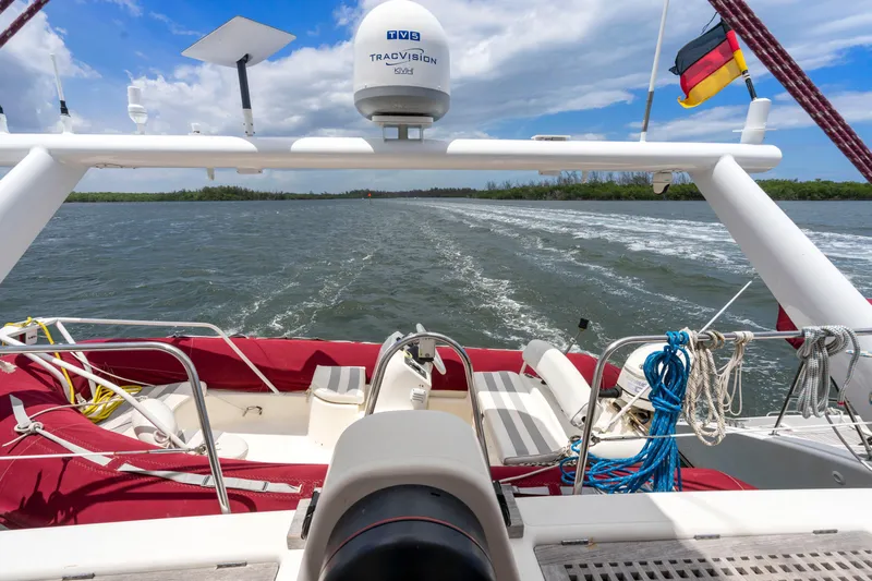 Tortuga Yacht Photos Pics Catana 582 yacht, 2001 model, sailing on open water with red seating and navigational equipment.