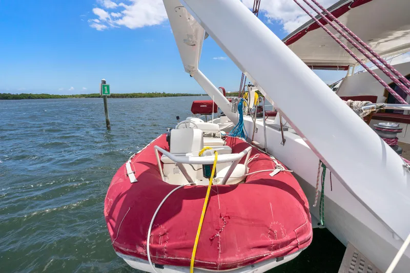 Tortuga Yacht Photos Pics Catana 582 sailboat with red dinghy on water, clear sky, 2001 model.