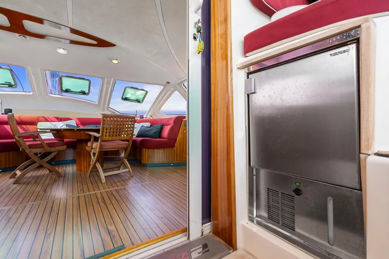 Tortuga Yacht Photos Pics Interior of 2001 Catana 582 yacht with wooden flooring and modern seating area.