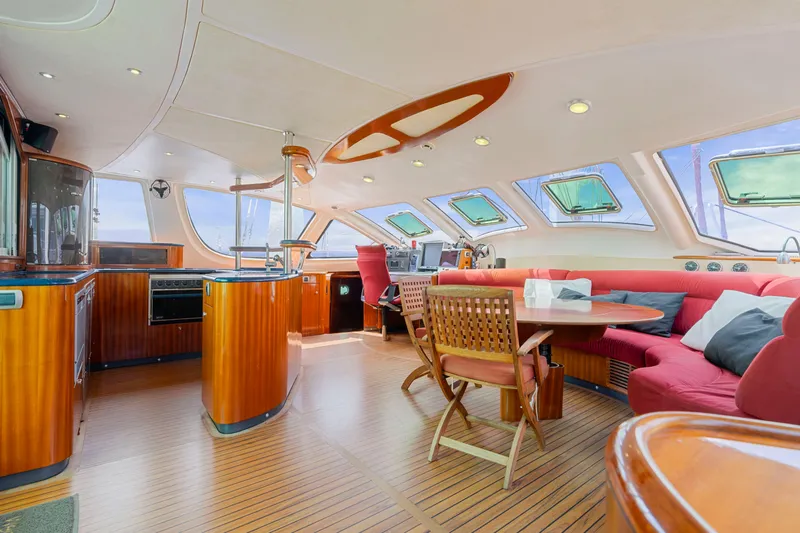 Tortuga Yacht Photos Pics Luxurious interior of a 2001 Catana 582 yacht with elegant wood finishes and spacious seating.