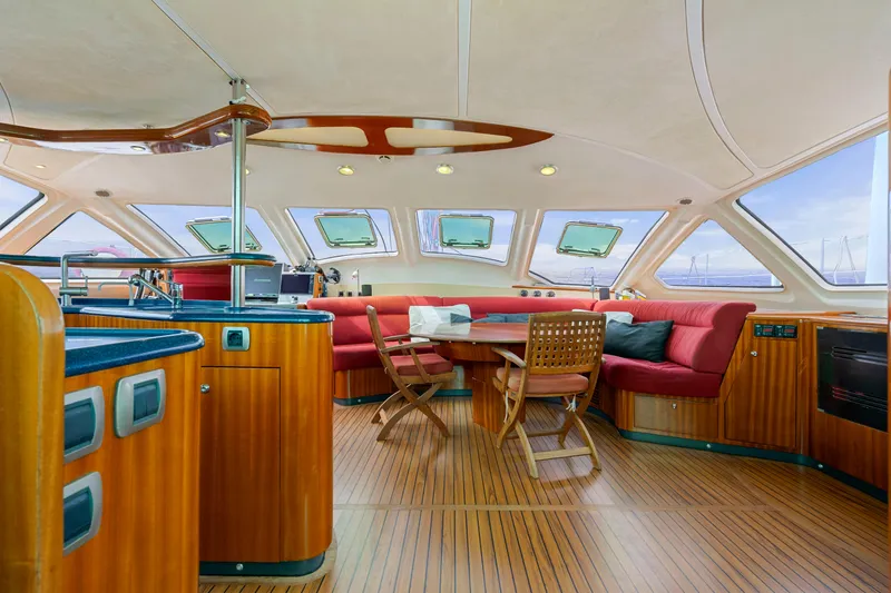 Tortuga Yacht Photos Pics Luxurious interior of 2001 Catana 582 yacht with wood finish and red seating.