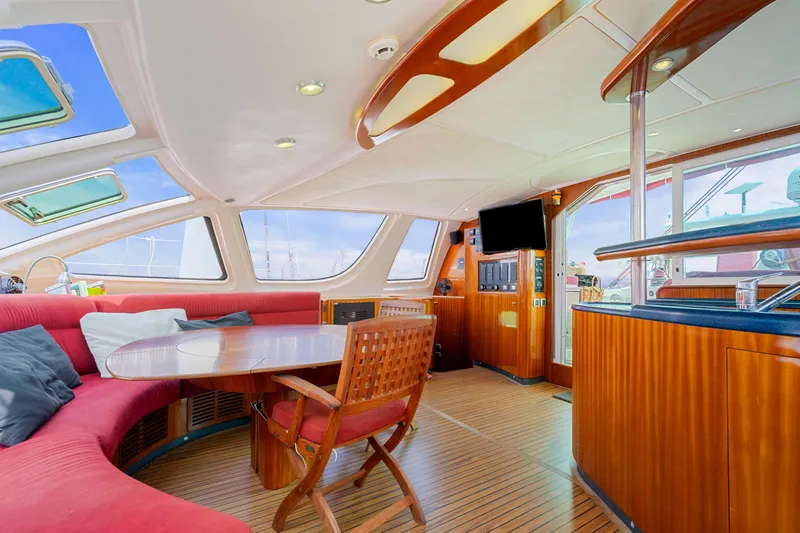 Tortuga Yacht Photos Pics Luxurious interior of 2001 Catana 582 yacht with elegant wood finishes and spacious seating.