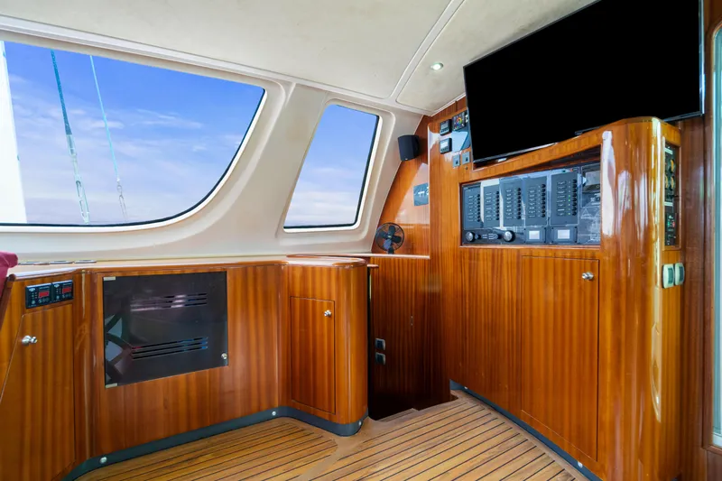 Tortuga Yacht Photos Pics Interior of 2001 Catana 582 yacht with wooden paneling and navigation equipment.