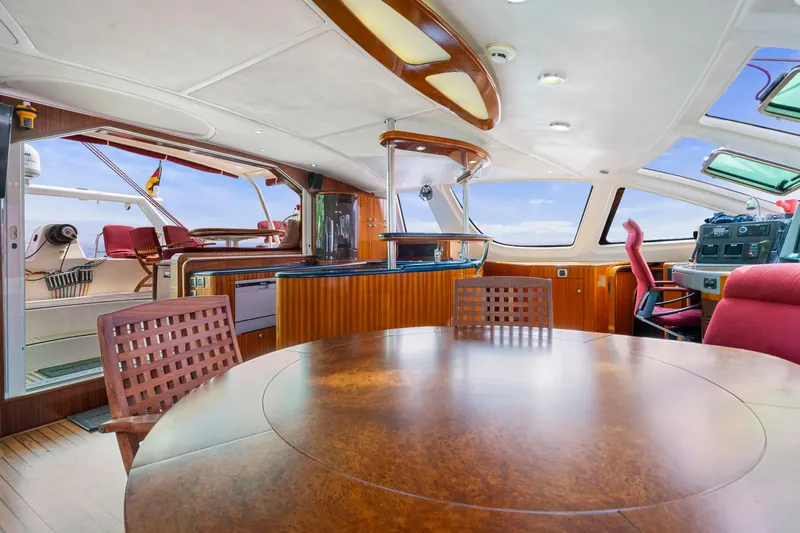 Tortuga Yacht Photos Pics Luxurious interior of a 2001 Catana 582 yacht with elegant wood finishes and panoramic windows.