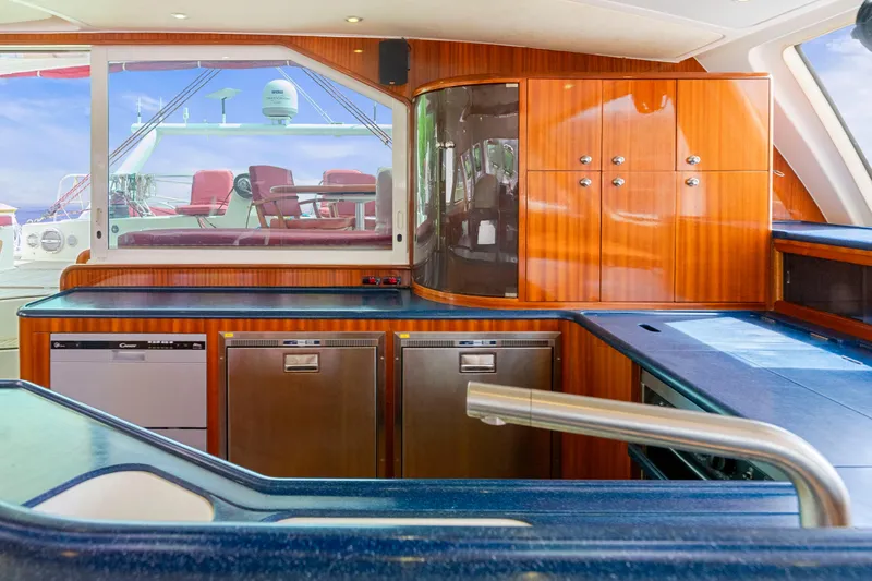 Tortuga Yacht Photos Pics Luxurious Catana 582 yacht kitchen interior with modern appliances and sleek wooden cabinetry, 2001 model.