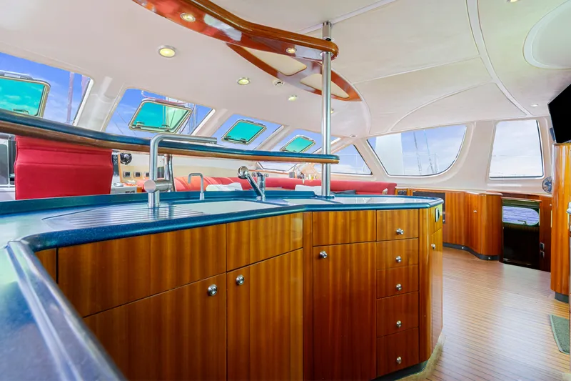 Tortuga Yacht Photos Pics Luxurious interior of 2001 Catana 582 yacht with modern kitchen and panoramic windows.