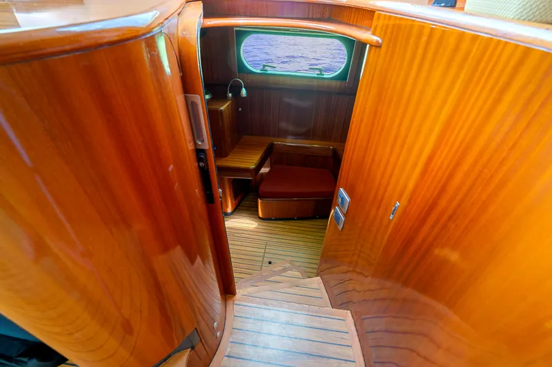 Tortuga Yacht Photos Pics Luxurious wooden interior of 2001 Catana 582 yacht, featuring elegant stairs and seating area.