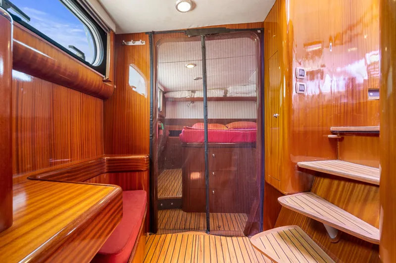 Tortuga Yacht Photos Pics Interior of 2001 Catana 582 yacht with wooden finishes and cozy seating area.