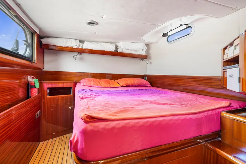 Tortuga Yacht Photos Pics Cozy cabin interior of 2001 Catana 582 yacht with vibrant pink bedding.