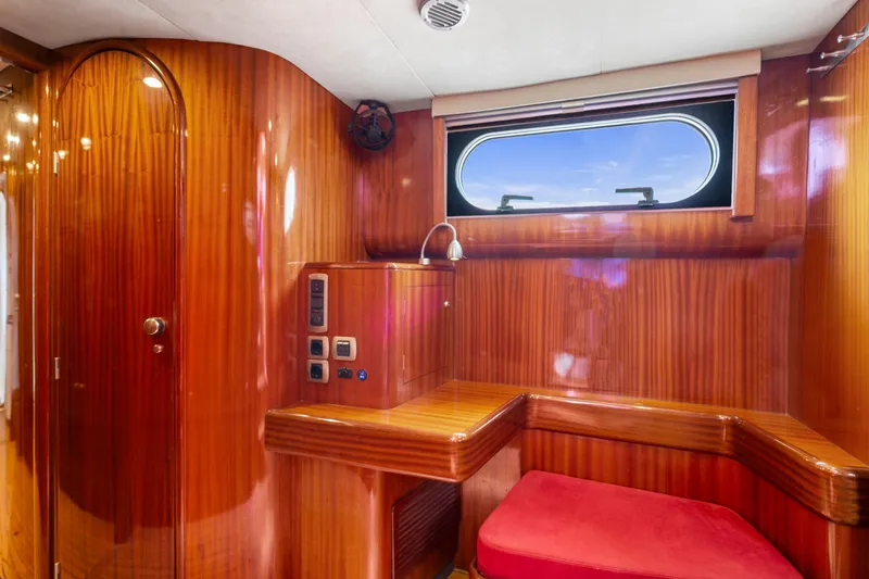 Tortuga Yacht Photos Pics Luxurious wooden interior of 2001 Catana 582 yacht with red seating and window.