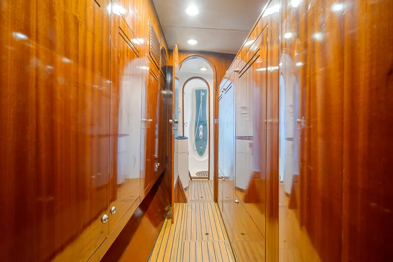Tortuga Yacht Photos Pics Luxurious wooden interior hallway of 2001 Catana 582 yacht, featuring sleek design and ambient lighting.