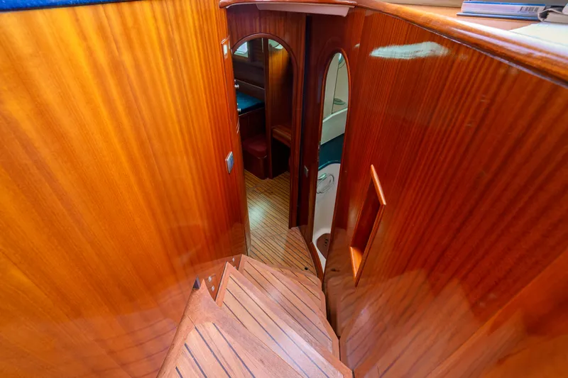 Tortuga Yacht Photos Pics Interior of 2001 Catana 582 yacht with polished wooden stairs and cabin view.