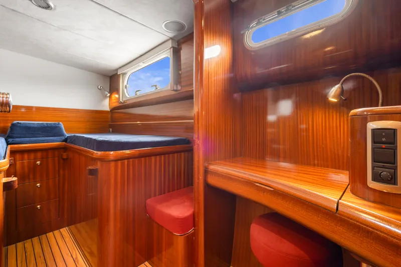 Tortuga Yacht Photos Pics Luxurious wooden interior of 2001 Catana 582 yacht cabin with bed and desk.