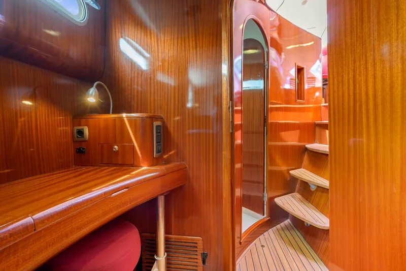 Tortuga Yacht Photos Pics Luxurious wooden interior of 2001 Catana 582 yacht with curved staircase and desk.