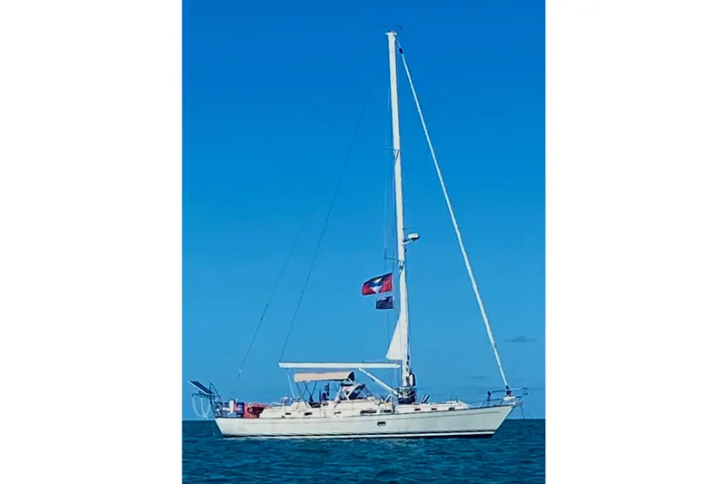 Eos Yacht Photos Pics Sailboat on open water, 2006 Passport 470 model, under clear blue sky.