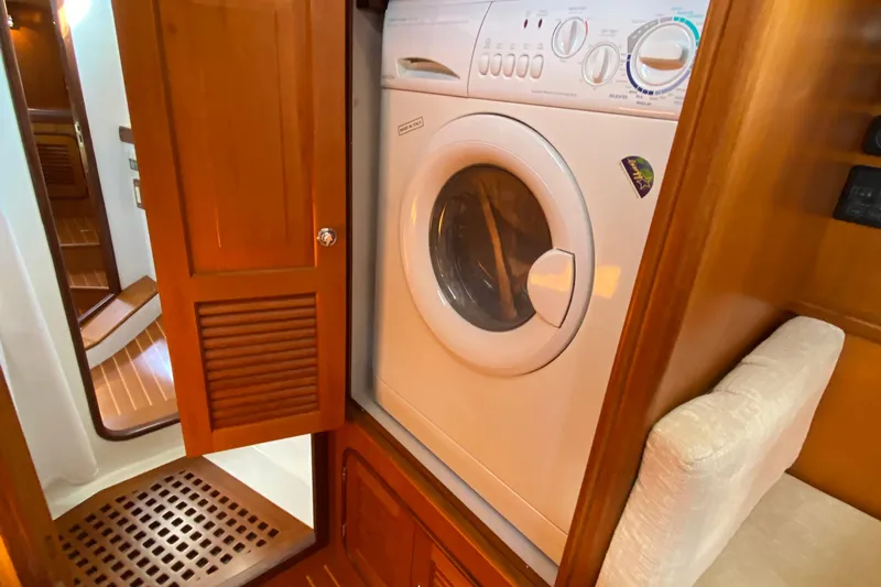 Eos Yacht Photos Pics Compact laundry area with a washing machine in a 2006 Passport 470 yacht.