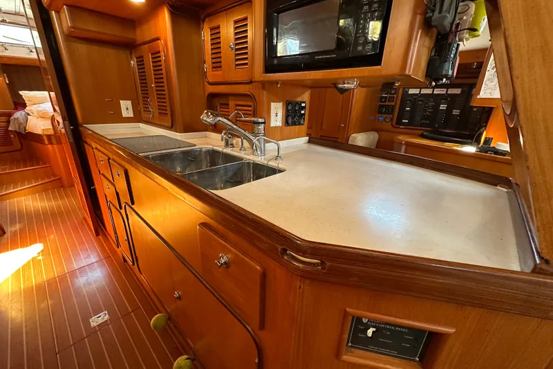 Eos Yacht Photos Pics Luxurious wooden interior of a 2006 Passport 470 yacht kitchen with modern amenities.