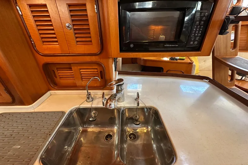 Eos Yacht Photos Pics Galley kitchen in 2006 Passport 470 yacht with sink and microwave.
