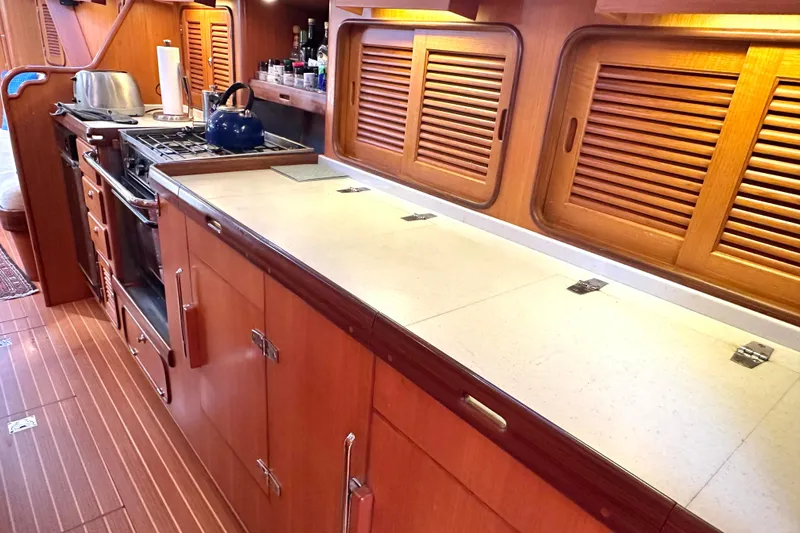 Eos Yacht Photos Pics Wooden galley kitchen in 2006 Passport 470 yacht with stove and storage cabinets.