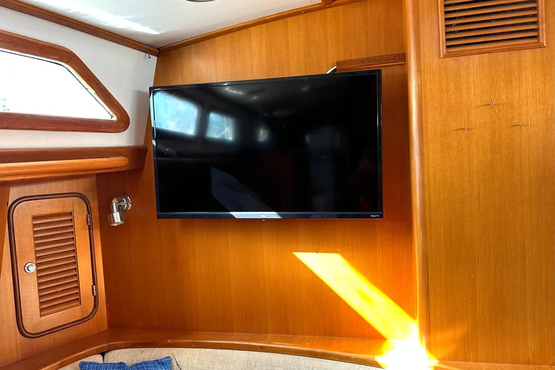 Eos Yacht Photos Pics Flat-screen TV mounted on wooden interior of 2006 Passport 470 yacht.