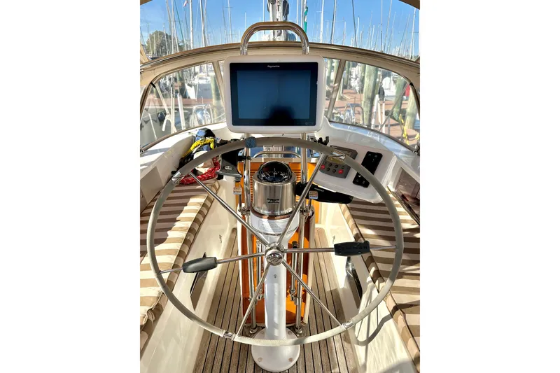 Eos Yacht Photos Pics Steering wheel and navigation system on 2006 Passport 470 sailboat.