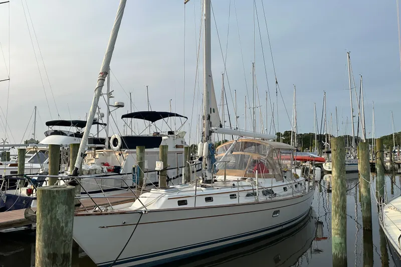 Eos Yacht Photos Pics Sailboat docked at marina, Passport 470 model, 2006, surrounded by other boats.