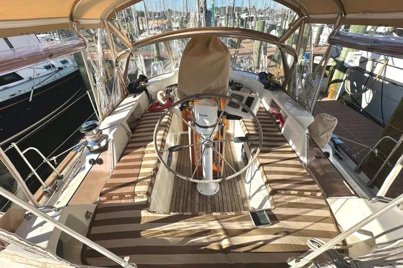 Eos Yacht Photos Pics Spacious cockpit of a 2006 Passport 470 sailboat with striped seating and covered helm.