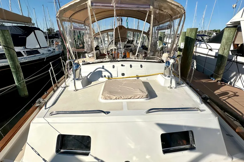 Eos Yacht Photos Pics Sailboat docked at marina, Passport 470 model, 2006, with covered cockpit area.