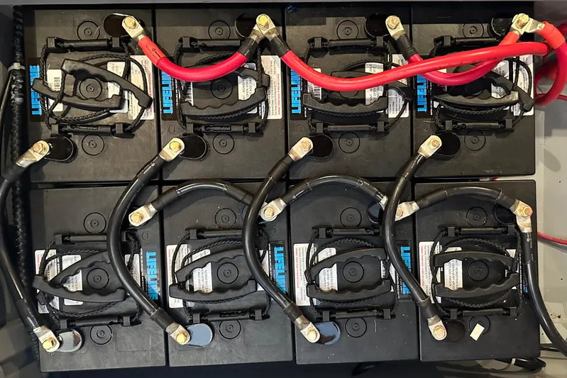 Eos Yacht Photos Pics Battery bank setup in a 2006 Passport 470, featuring Lifeline batteries and connected cables.