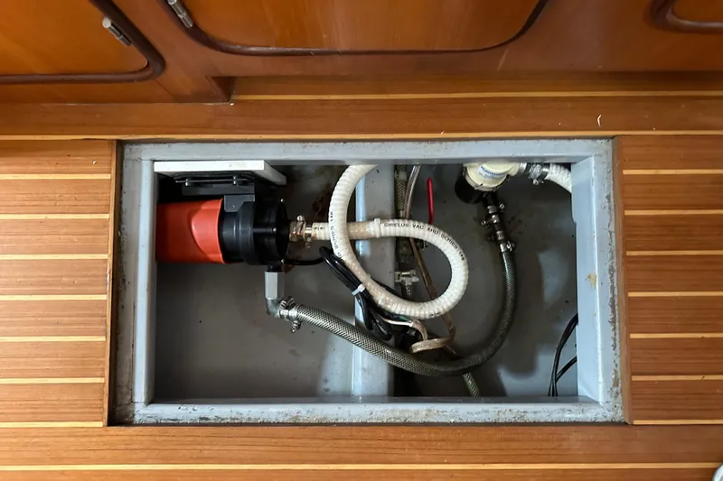 Eos Yacht Photos Pics Bilge pump system in a 2006 Passport 470 yacht, with wooden flooring.