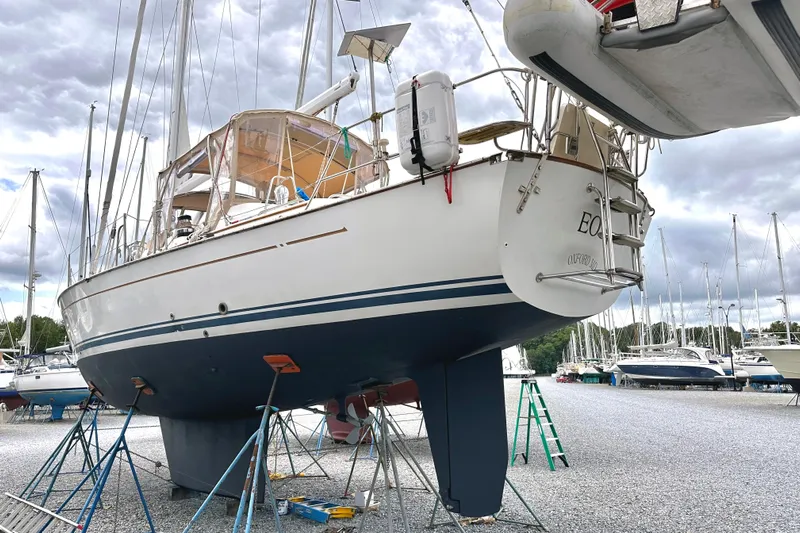 Eos Yacht Photos Pics Sailboat Passport 470, 2006 model, docked in a marina with overcast skies.