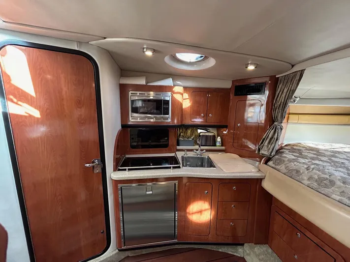  Yacht Photos Pics Interior of 2015 Crownline 350 SY yacht with modern kitchen amenities.