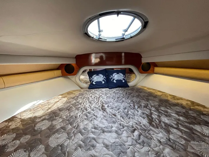  Yacht Photos Pics Interior cabin of 2015 Crownline 350 SY yacht with cozy bedding and porthole.