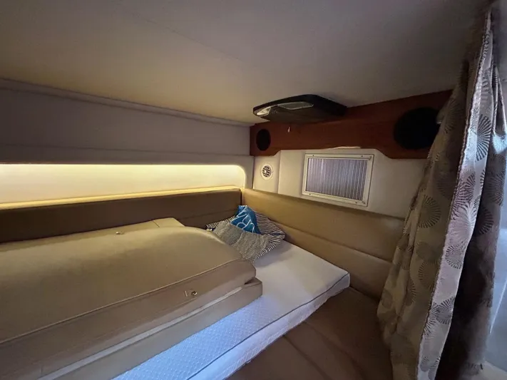  Yacht Photos Pics 2015 Crownline 350 SY cabin interior with bed, cushions, and ambient lighting.