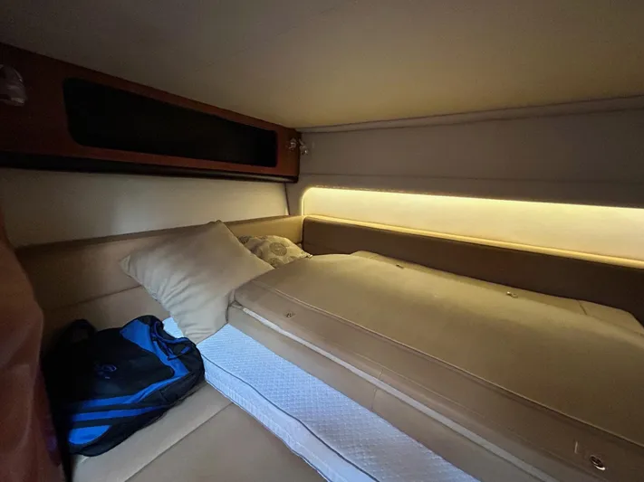  Yacht Photos Pics Cozy cabin interior of 2015 Crownline 350 SY yacht with bed and ambient lighting.