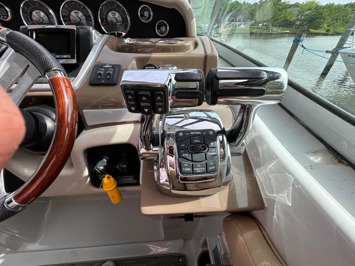  Yacht Photos Pics Control panel of a 2015 Crownline 350 SY boat with chrome throttle levers.