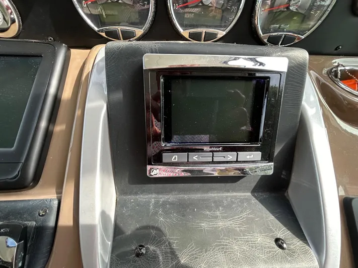  Yacht Photos Pics Dashboard of a 2015 Crownline 350 SY boat with electronic display and gauges.