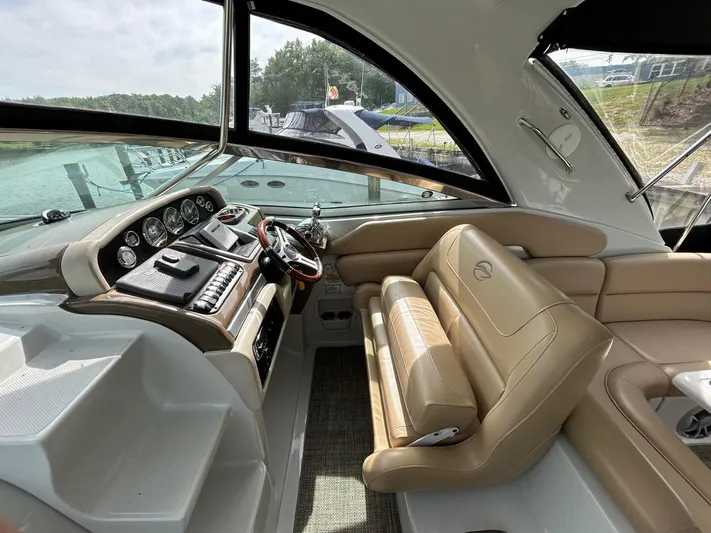  Yacht Photos Pics 2015 Crownline 350 SY yacht interior with beige seating and modern dashboard.