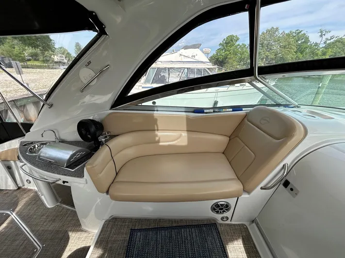  Yacht Photos Pics 2015 Crownline 350 SY boat interior with beige seating and a compact kitchenette.