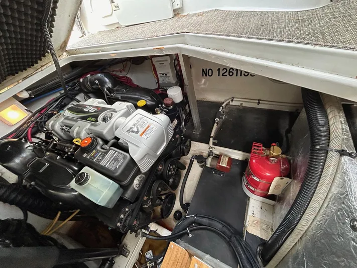  Yacht Photos Pics Engine compartment of a 2015 Crownline 350 SY boat, featuring a well-maintained engine and equipment.