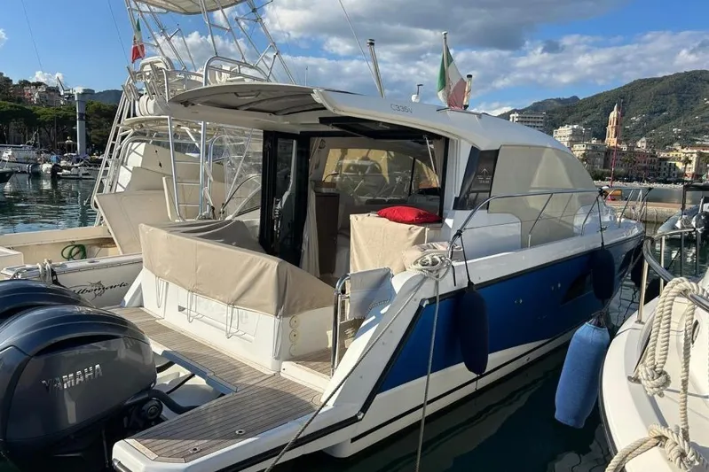  Yacht Photos Pics 2022 Sealine C335V yacht docked in a scenic marina with mountains in the background.