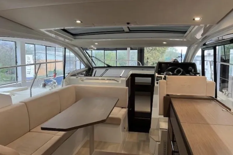  Yacht Photos Pics Interior of 2022 Sealine C335V yacht, featuring modern seating and helm area.
