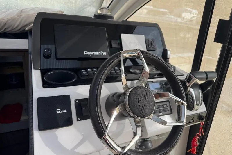  Yacht Photos Pics Helm of 2022 Sealine C335V boat with Raymarine navigation system and modern controls.