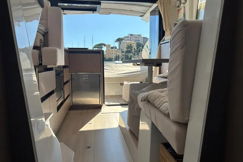  Yacht Photos Pics Interior of 2022 Sealine C335V yacht, featuring modern kitchen and seating area with scenic view.
