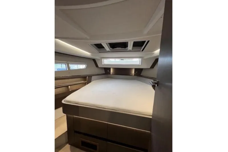  Yacht Photos Pics 2022 Sealine C335V cabin interior with bed and windows.